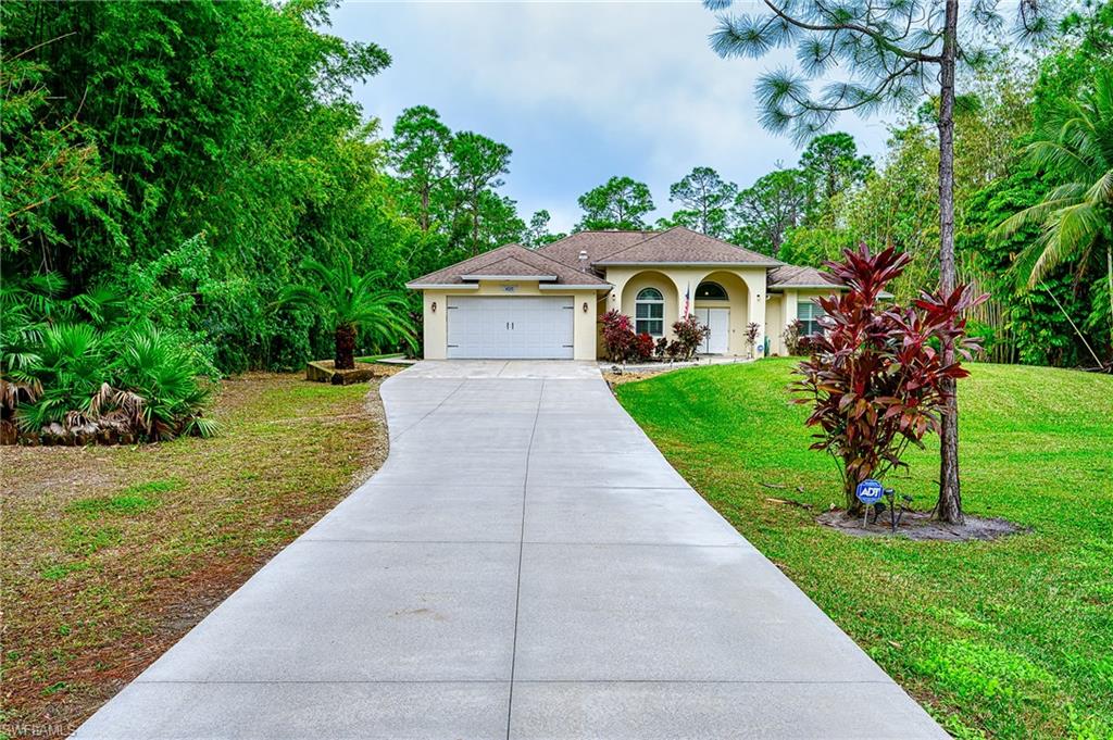 View of front facade with a front yard and a garage