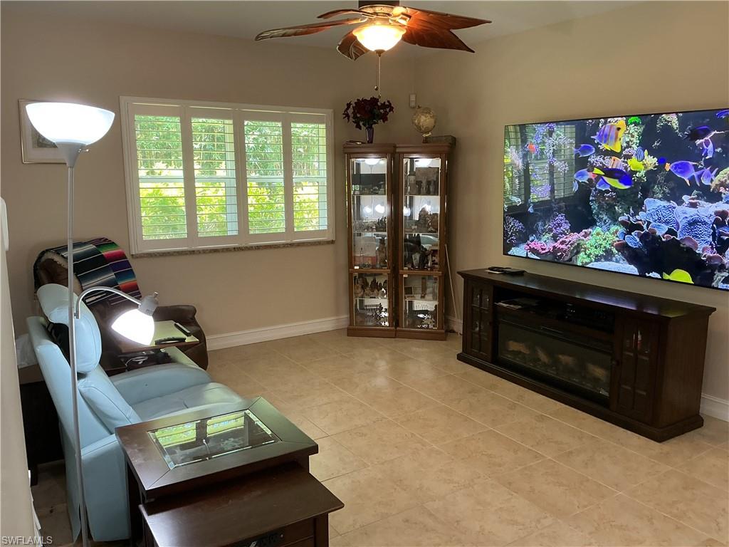 Family Room with the 85" TV that stays with the fireplace.