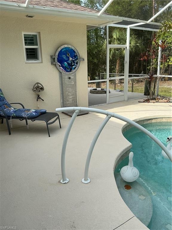 Lanai with its own unique scale shower. Outside screened area is fire pit