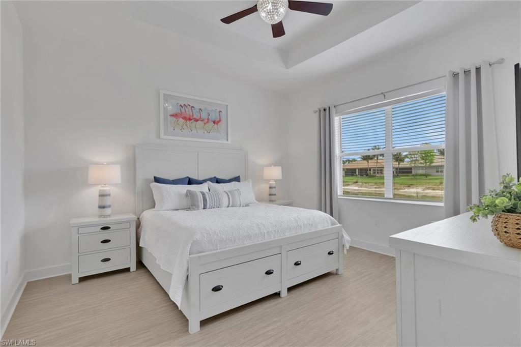 Recessed tray ceiling with a modern ceiling fan and crystal light fixture