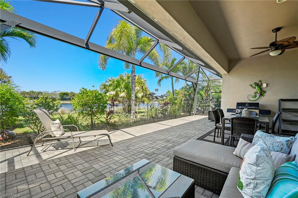Expansive screened lanai featuring a paver patio and direct water access