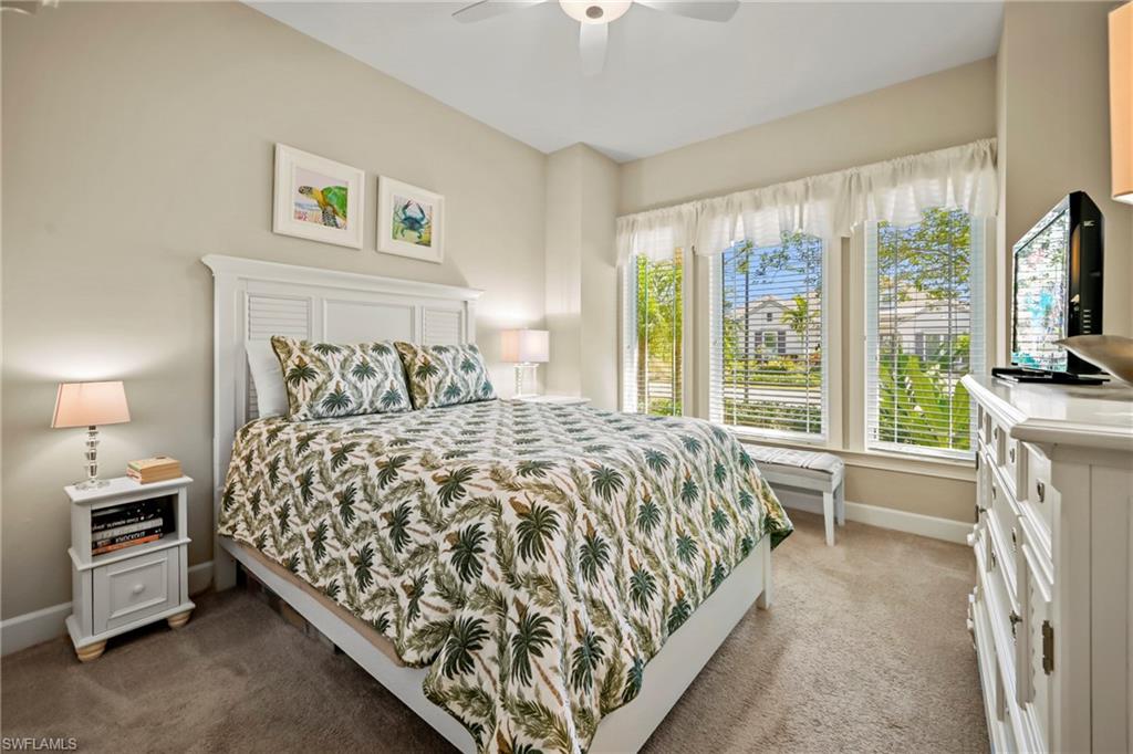 Neutral tone walls with a white slatted headboard and matching bedside tables
