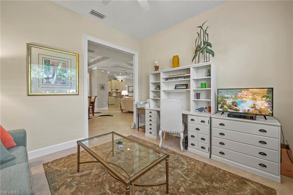 Versatile living space featuring neutral wall tones and a wide doorway