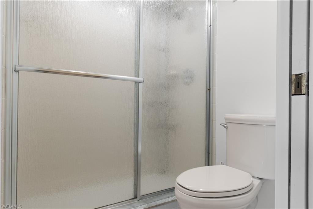Frosted glass shower enclosure with chrome hardware