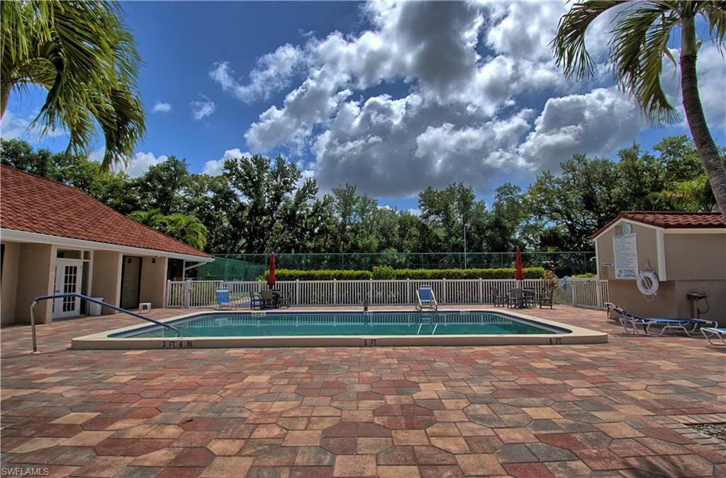 Outdoor swimming pool with integrated steps and a surrounding paver patio