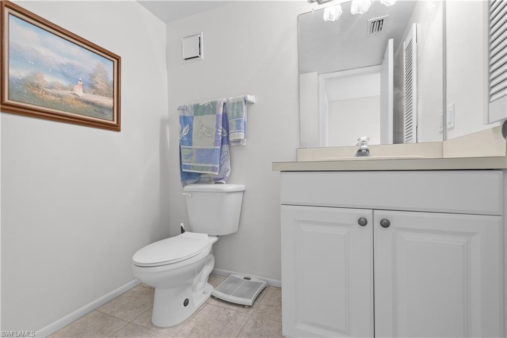 Guest bathroom featuring a white vanity