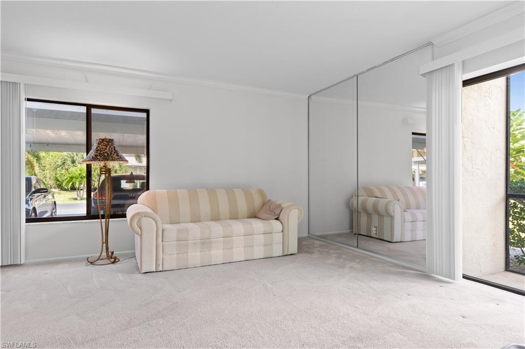 Carpeted room with a mirrored wall.