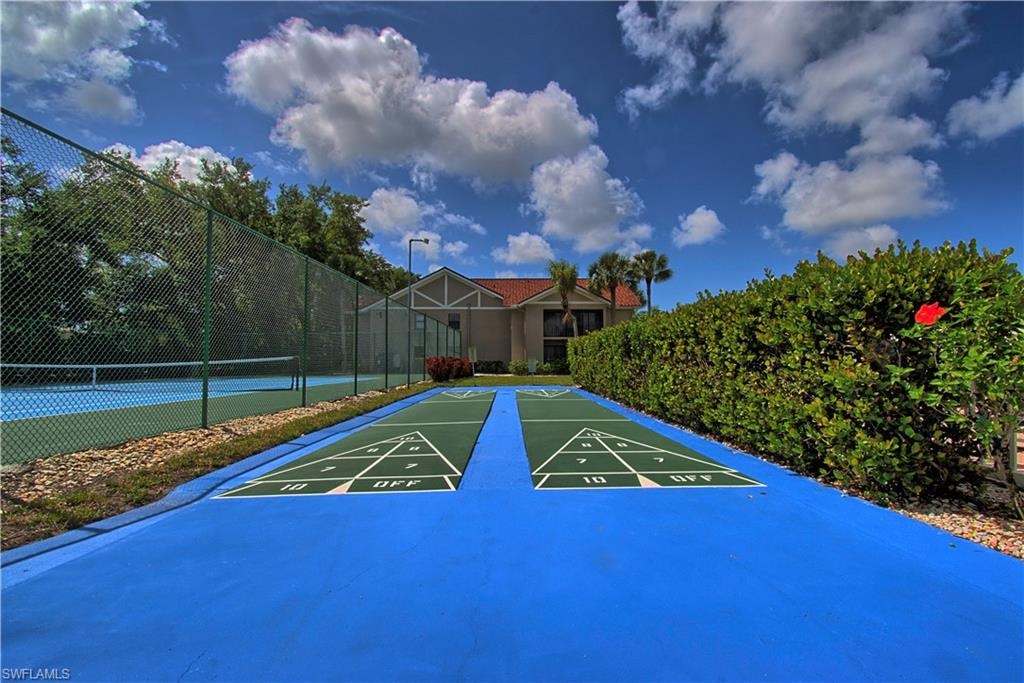 Two shuffleboard courts with a blue perimeter and green playing surfaces