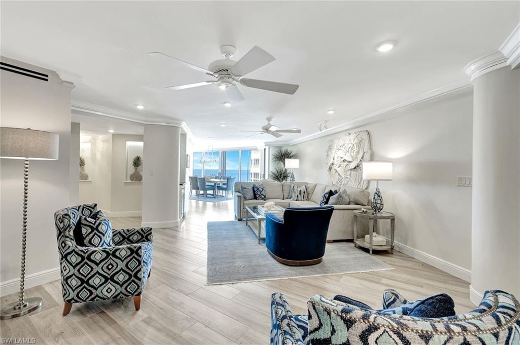 Living room featuring ceiling fan, light wood finished floors, recessed lighting, baseboards, and ornamental molding