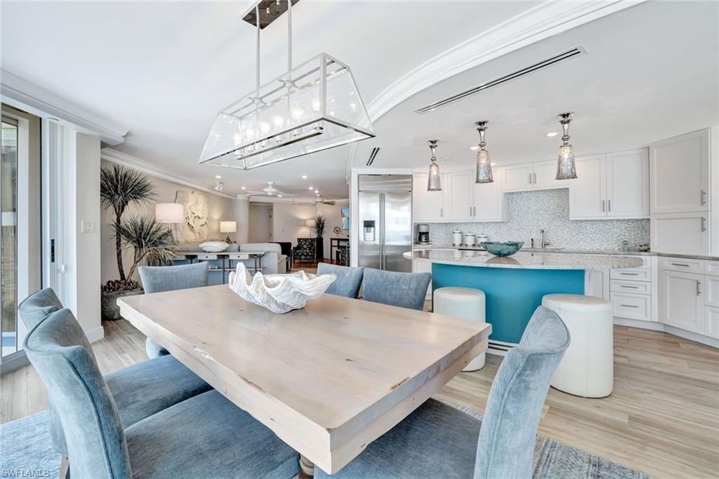 Dining room featuring ornamental molding, recessed lighting, and light wood-style flooring