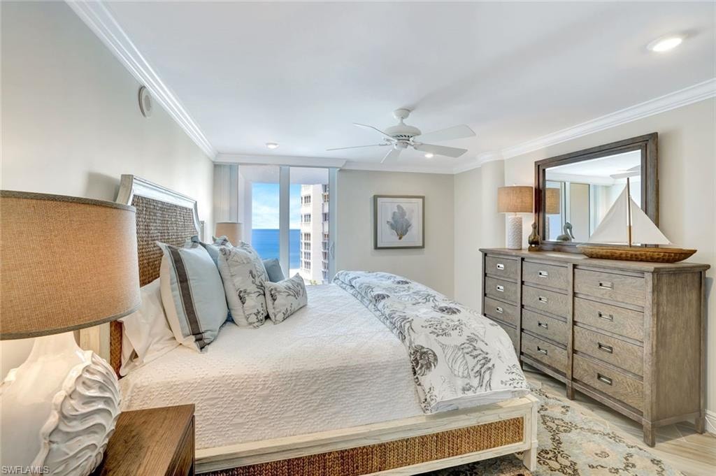 Bedroom featuring a ceiling fan, ornamental molding, and light wood finished floors