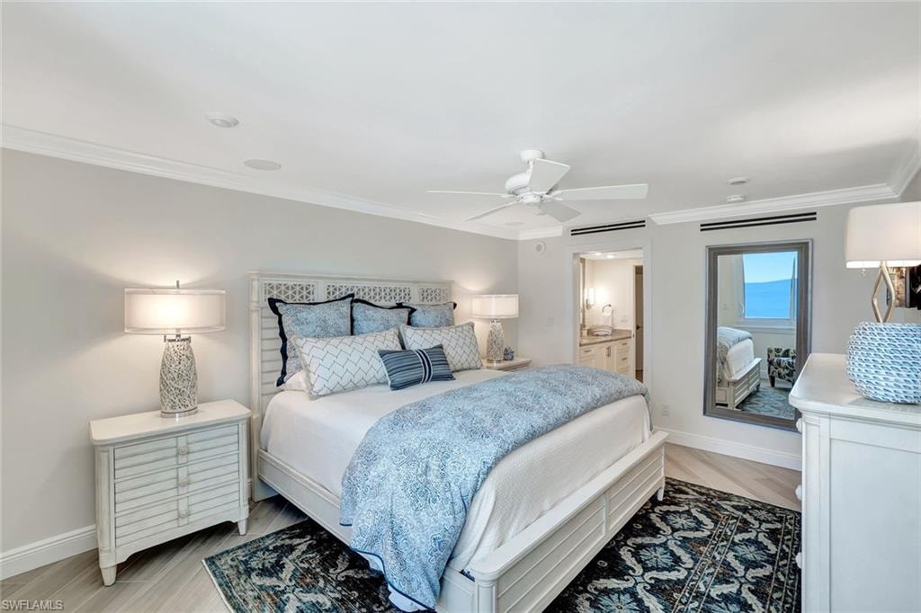 Bedroom featuring crown molding, baseboards, ensuite bathroom, and a ceiling fan