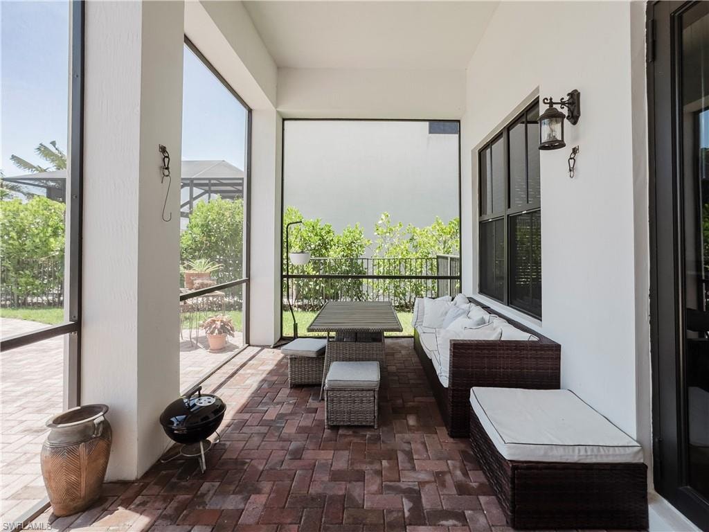 Sunroom with plenty of natural light and outdoor lounge area