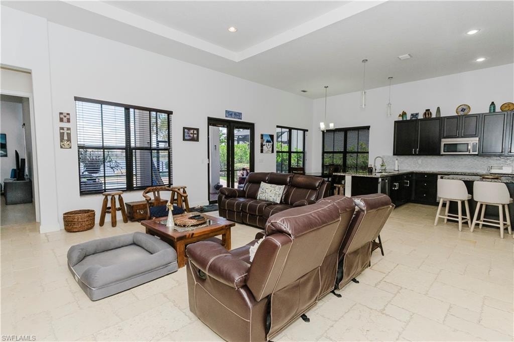 Living room featuring recessed lighting and stone tile flooring