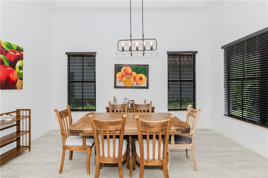 Dining space with a chandelier and light wood-style floors