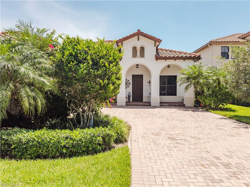 Mediterranean / spanish home with a tile roof and stucco siding