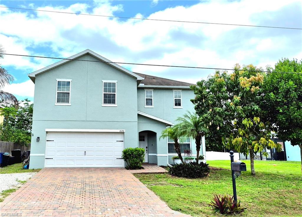 Two-story stucco residence with a two-car garage