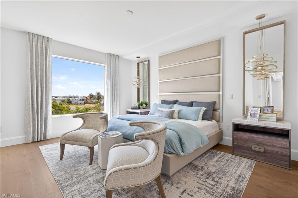 Master Suite featuring coastal contemporary decor , light wood floors and large picture window
