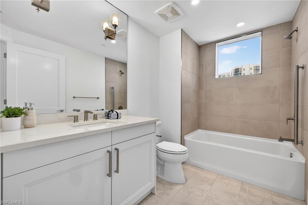 Bathroom 3 Full bathroom featuring shower / bath combo with shower curtain, vanity, and recessed lighting