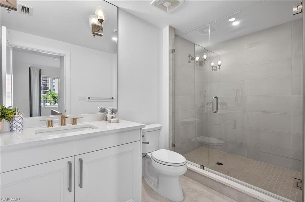 Bathroom 2 with beautiful tiled shower and tile flooring, sleek vanity and stone counter