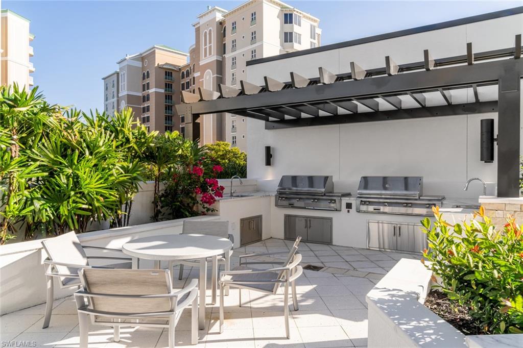 Expansive outdoor kitchen with two oversized gas grills.