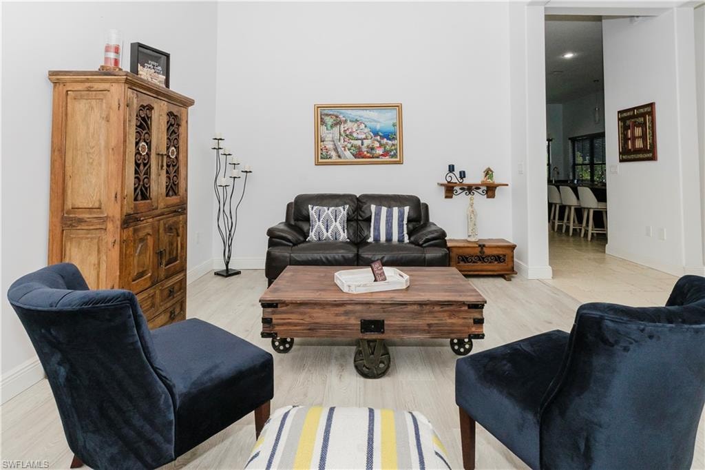 Living room featuring baseboards and light wood-type flooring