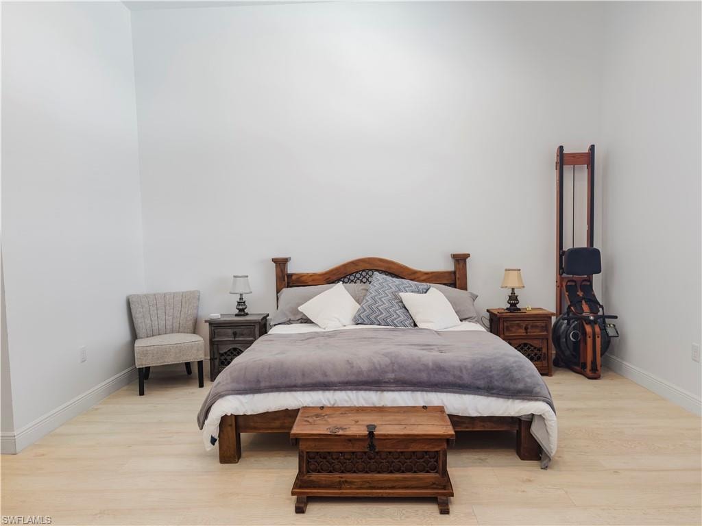 Bedroom featuring light wood finished floors and baseboards