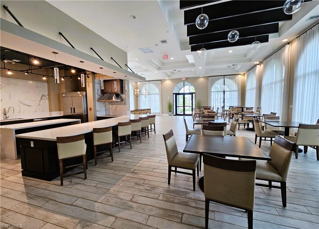 Dining space featuring light wood-style flooring and a raised ceiling