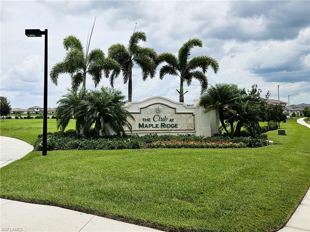 Community / neighborhood sign with a lawn