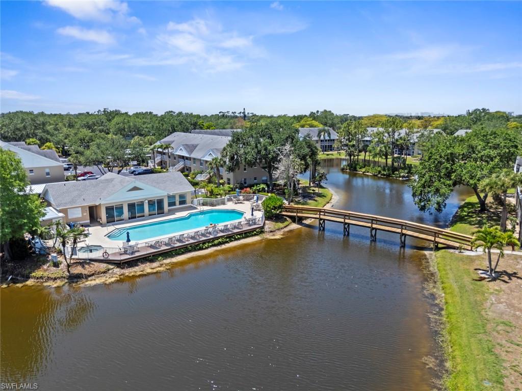 Community amenities featuring a central pool, a spa, and sun loungers
