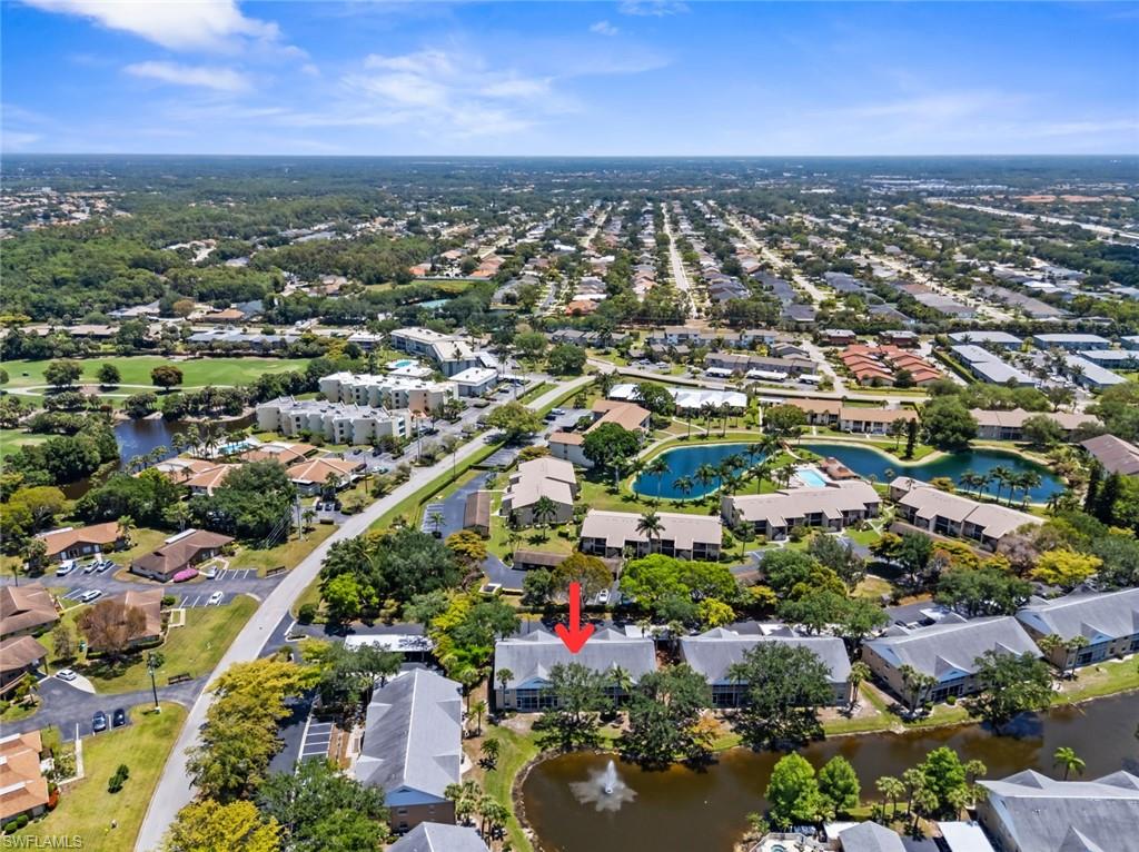 Aerial perspective of the property, showcasing a prominent water feature with a fountain