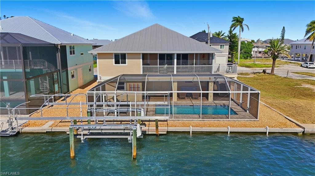 Featuring screened-in pool, patio, and boat lift - Virtually Edited Image