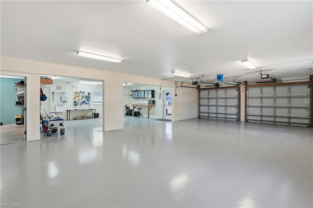 View of Huge Garage with ample storage and workout area - Virtually Edited Image