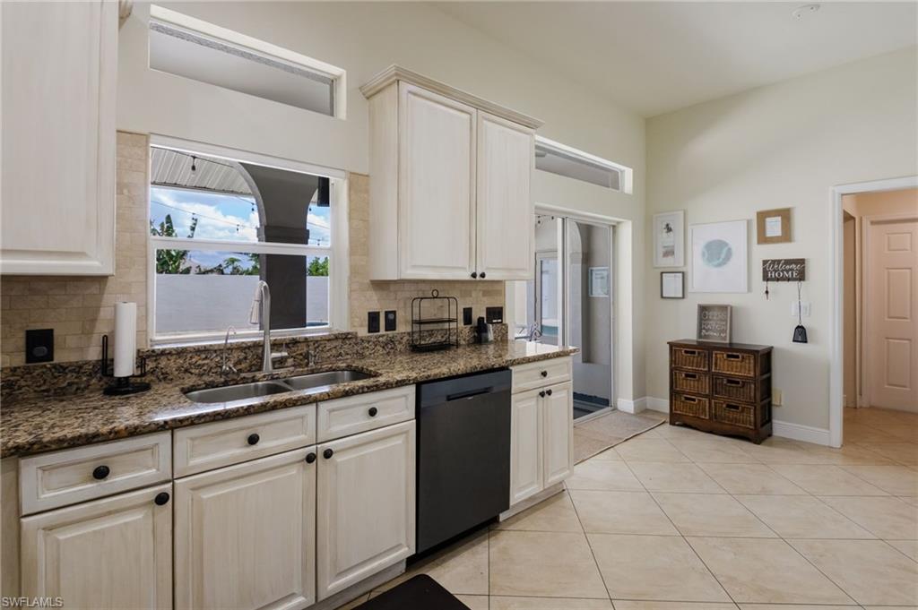 The kitchen has direct access to the courtyard pool area through the sliding glass doors.
