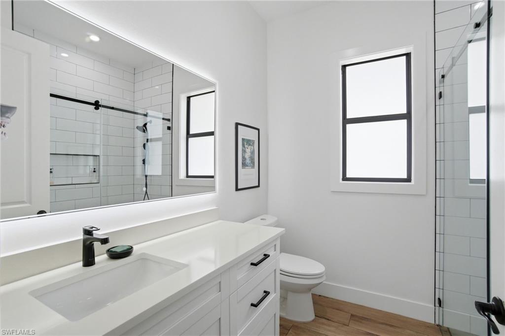 Contemporary bathroom featuring a white vanity with shaker-style cabinetry, a rectangular undermount sink, and a quartz-finish countertop