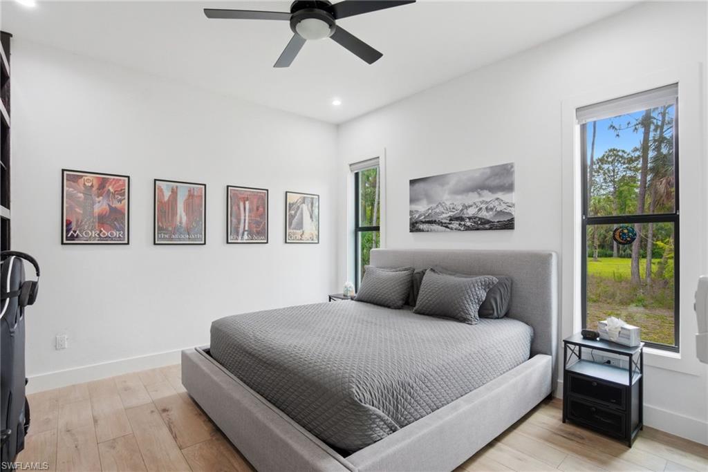 Bedroom featuring wood-finish flooring, recessed lighting, and a contemporary ceiling fan