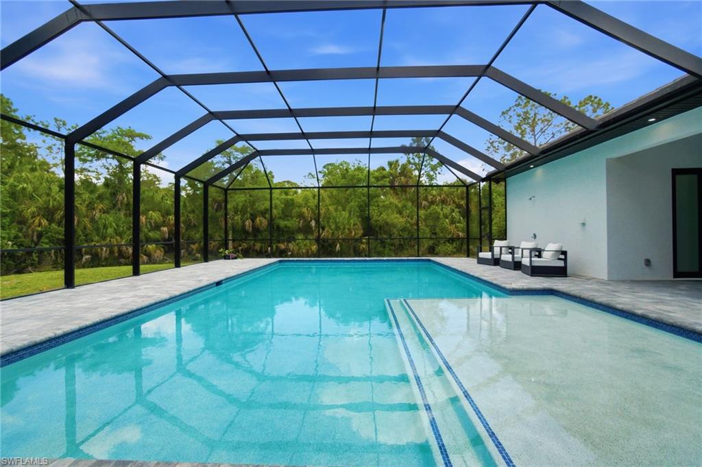 Screened lanai with a rectangular pool and integrated spa
