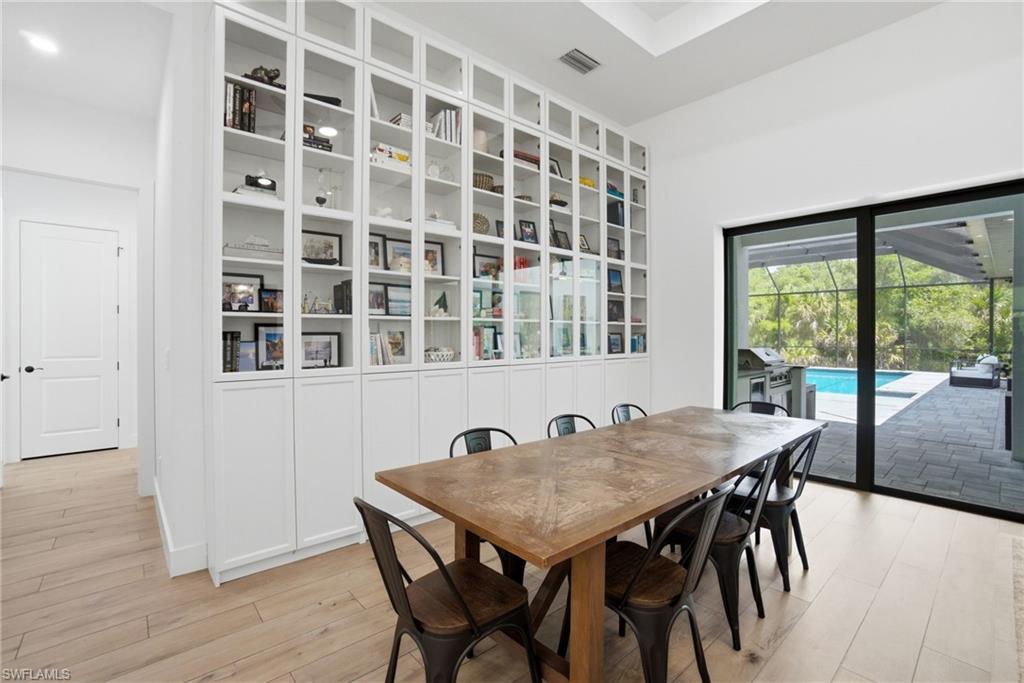 Floor-to-ceiling built-in cabinetry with glass-front display shelves