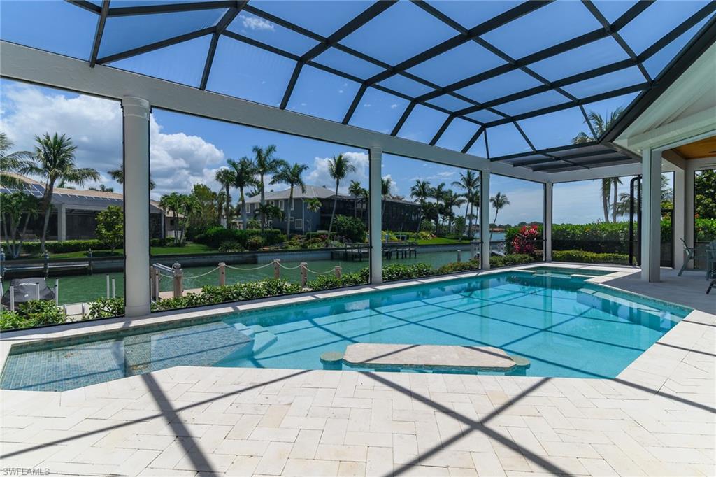 Amazing outdoor pool area featuring a rectangular pool, integrated spa, perfect for entertaining