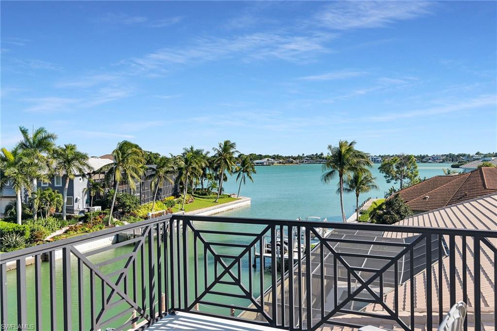 Balcony featuring a decorative black metal railing and expansive water frontage view of  Roberts Bay