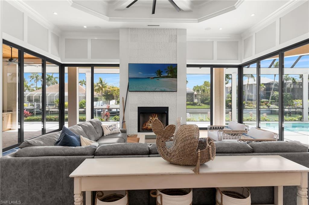Expansive living space featuring a textured fireplace surround, integrated television, and a recessed fireplace