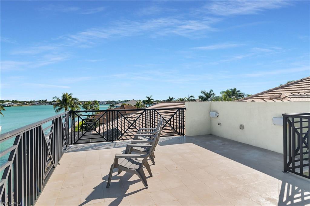 Rooftop terrace with tiled flooring and decorative metal railings