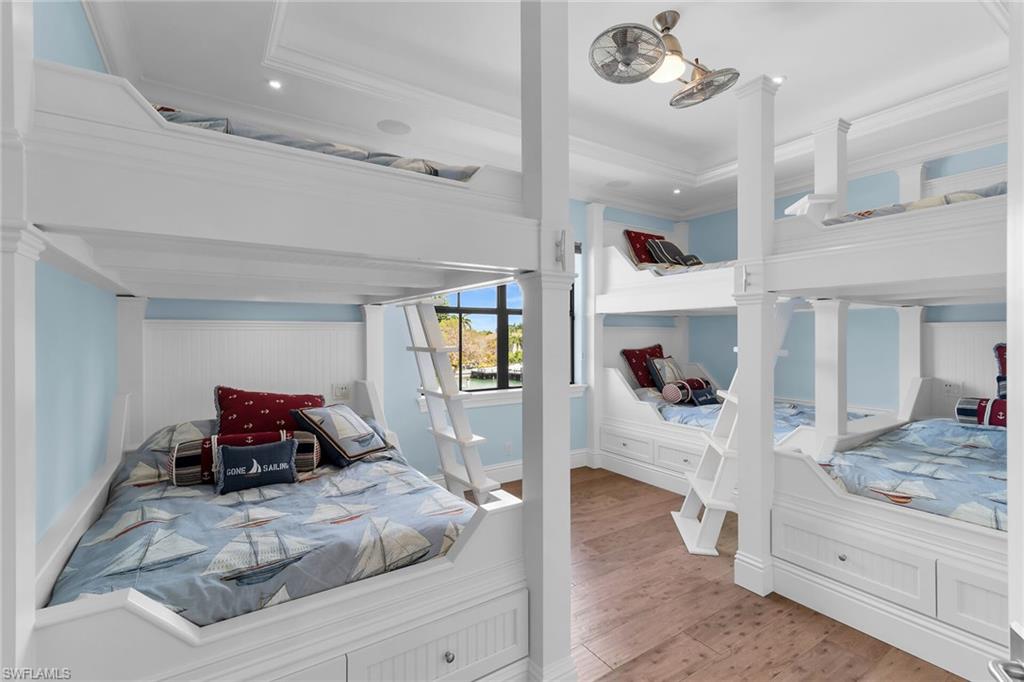 Custom built-in bunk beds featuring white wood paneling and integrated storage drawers