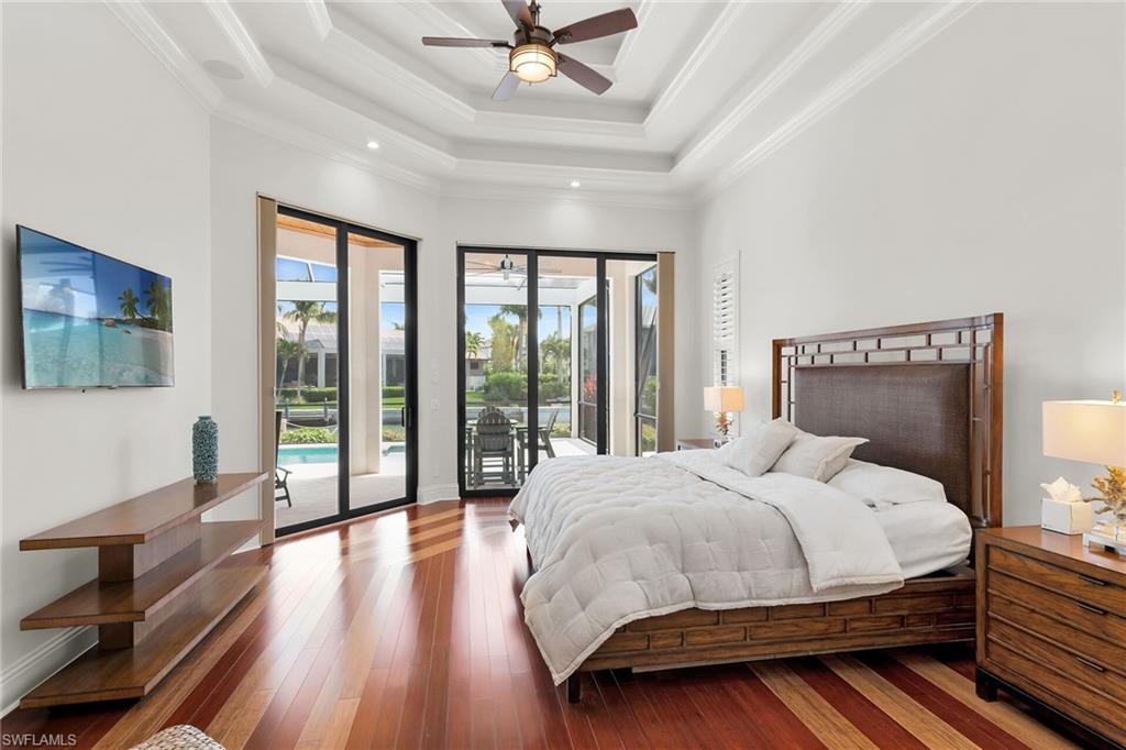 Spacious interior featuring wood-finish flooring, a coffered ceiling with recessed lighting, and a ceiling fan