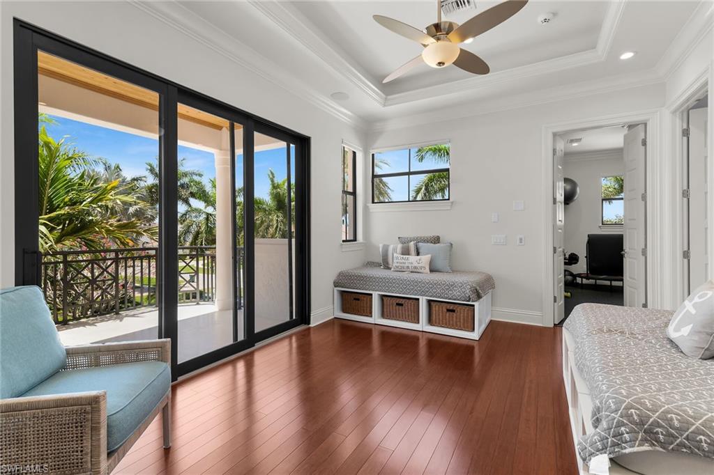 Sliding glass doors opening to a balcony with black metal railings