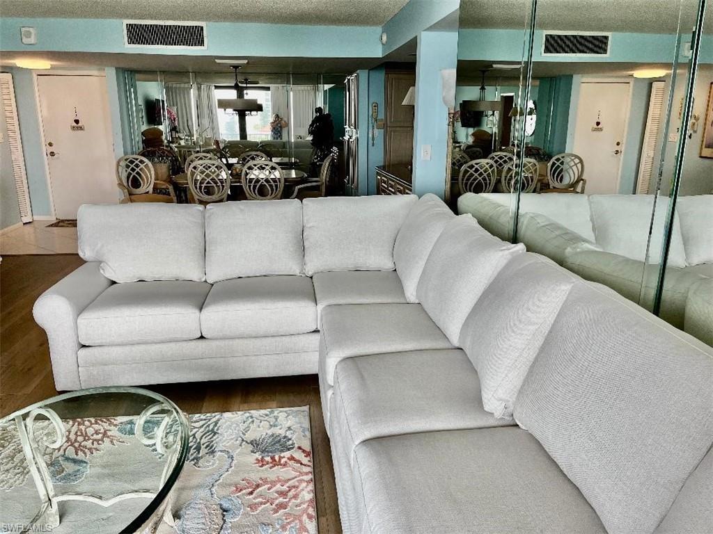 Living room featuring a textured ceiling and hardwood / wood-style floors