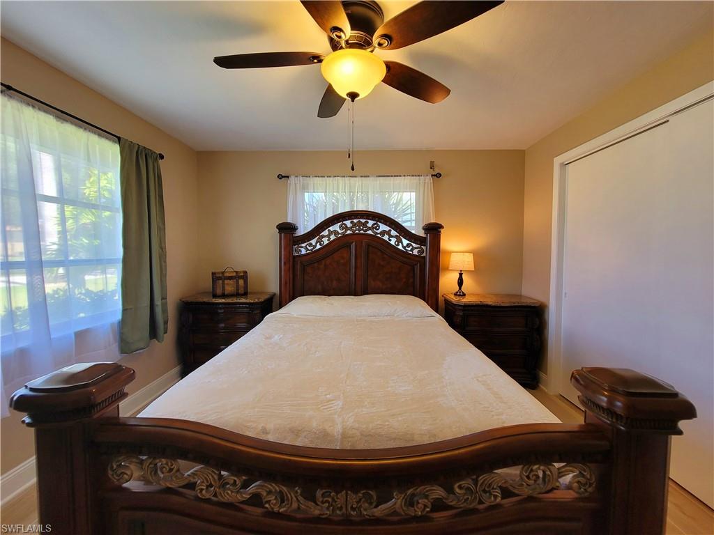 Neutral wall paint, wood-finish flooring, and a ceiling fan with integrated lighting