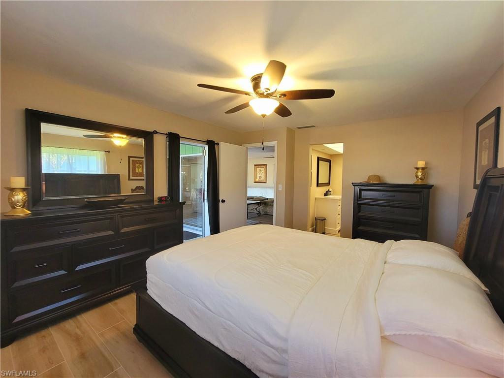 Bedroom featuring light wood-finish flooring and a ceiling fan with integrated lighting