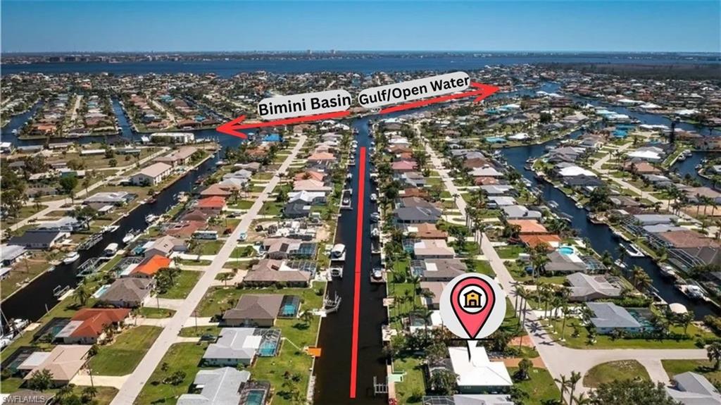 Aerial perspective showcasing a canal-front property with direct water access