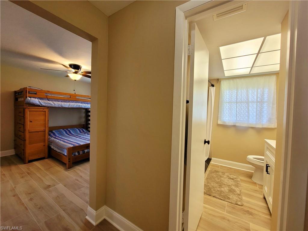 Bedroom featuring wood-finish flooring and a ceiling fan with integrated lighting